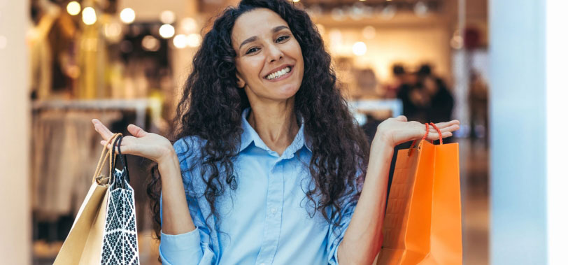 Happy customer holding shopping bags