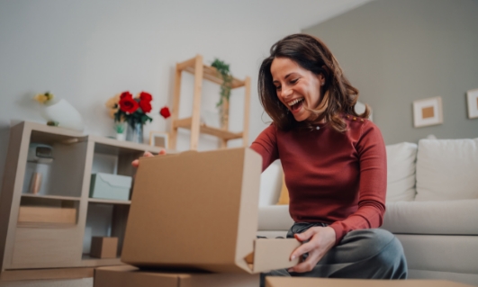 Customer unboxing a purchase from a rewards marketplace with a wide range of products